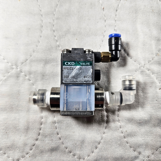 CKD AMD22 4V2 pneumatic solenoid air valve front view, industrial automation MRO compressed air valve component. American Industrial Parts Group.