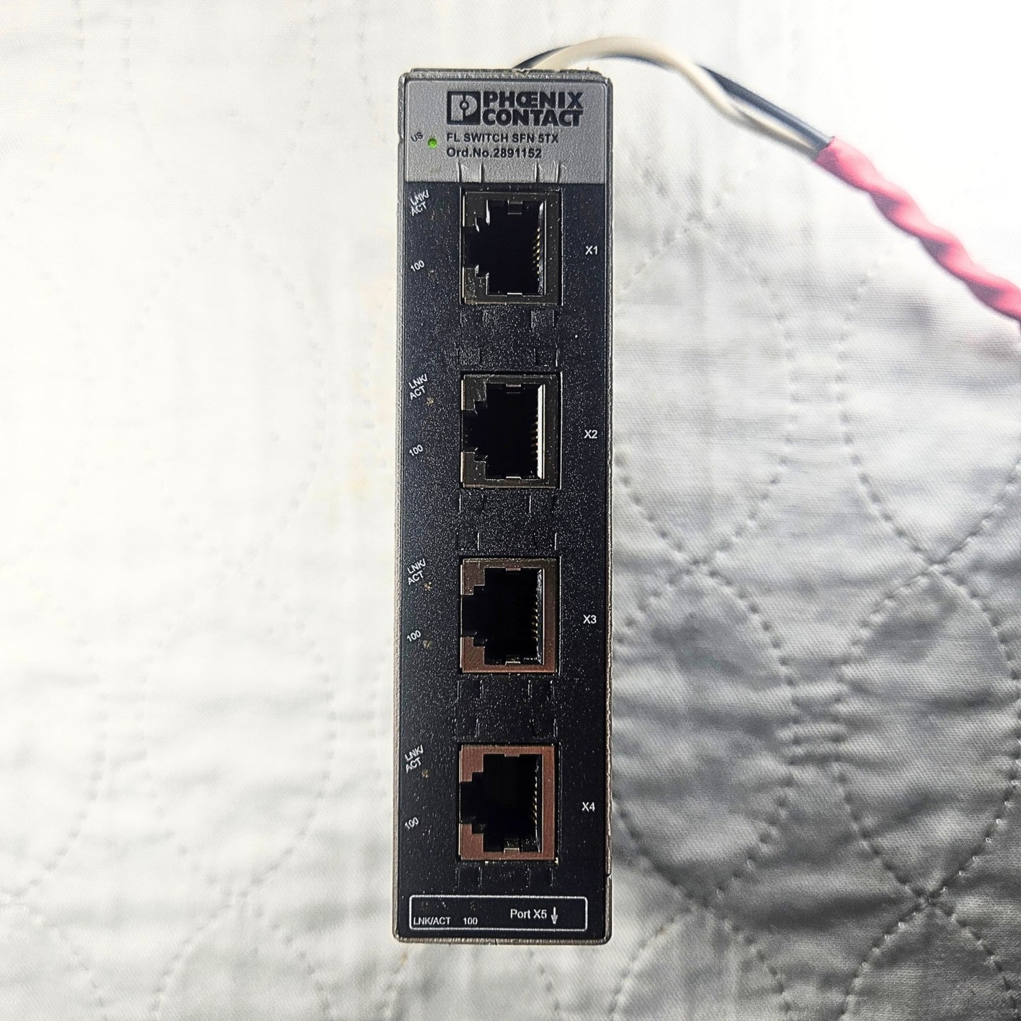 Phoenix Contact FL SFN 5TX ethernet module front view. American Industrial Parts Group.
