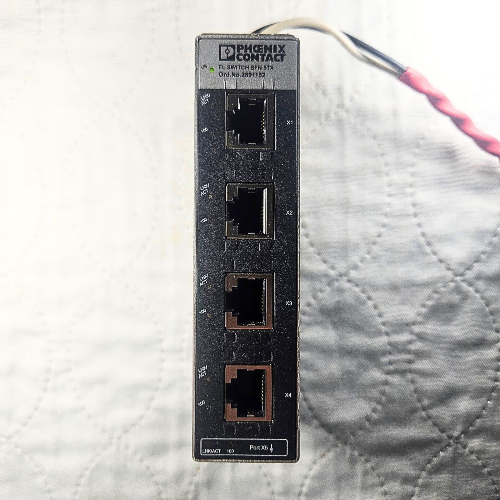 Phoenix Contact FL SFN 5TX ethernet module front view. American Industrial Parts Group.
