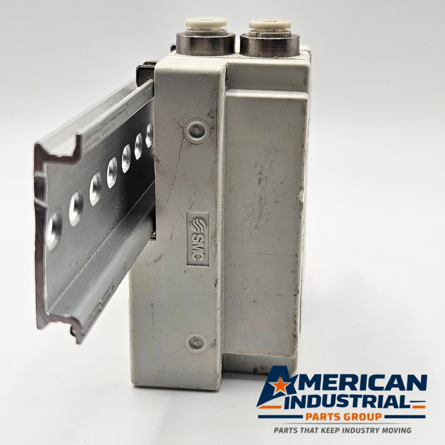 SMC pneumatic valve manifold end block label detail, industrial automation MRO pneumatic manifold replacement part. American Industrial Parts Group.
