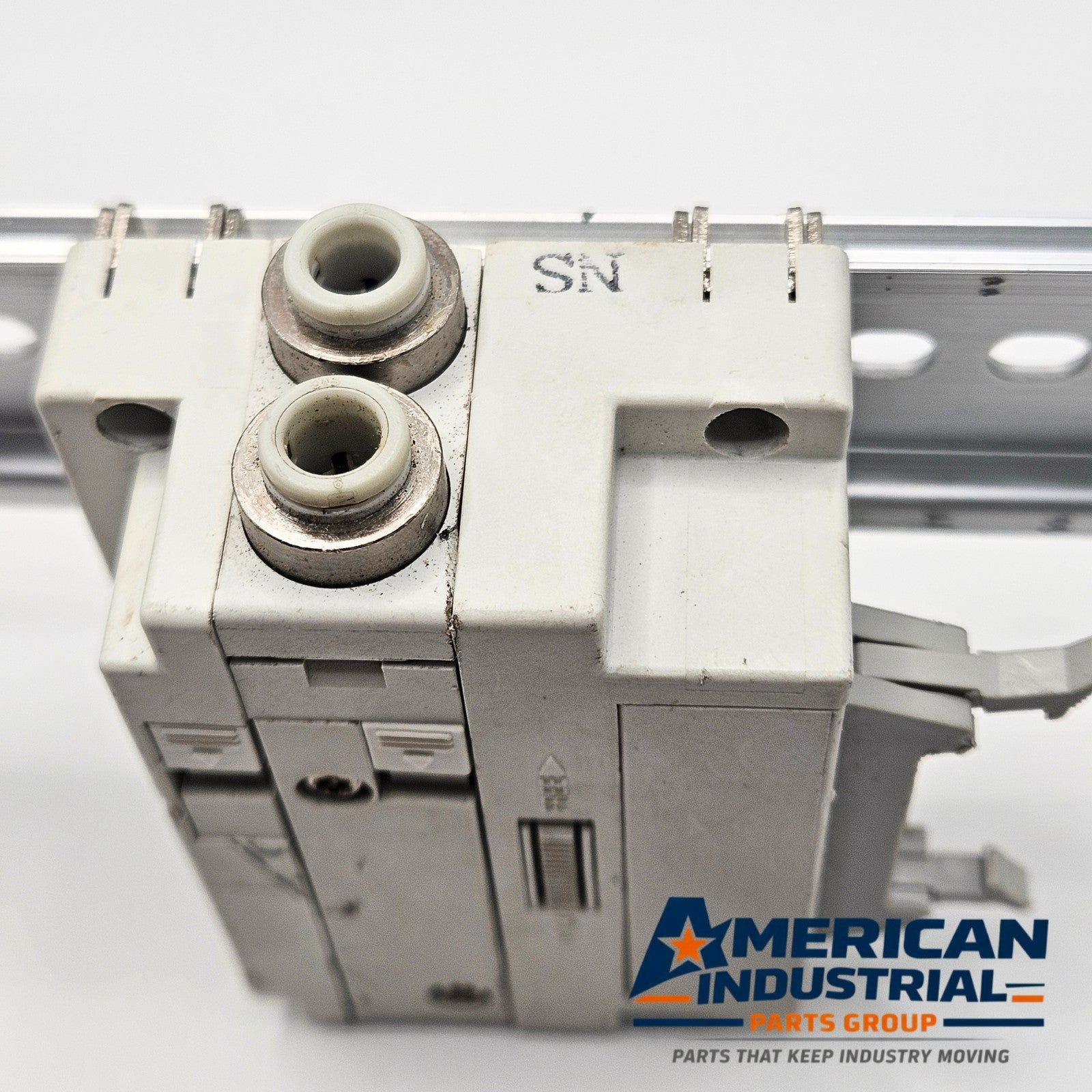 SMC pneumatic valve manifold end block mounting detail, industrial automation MRO pneumatic manifold hardware. American Industrial Parts Group.