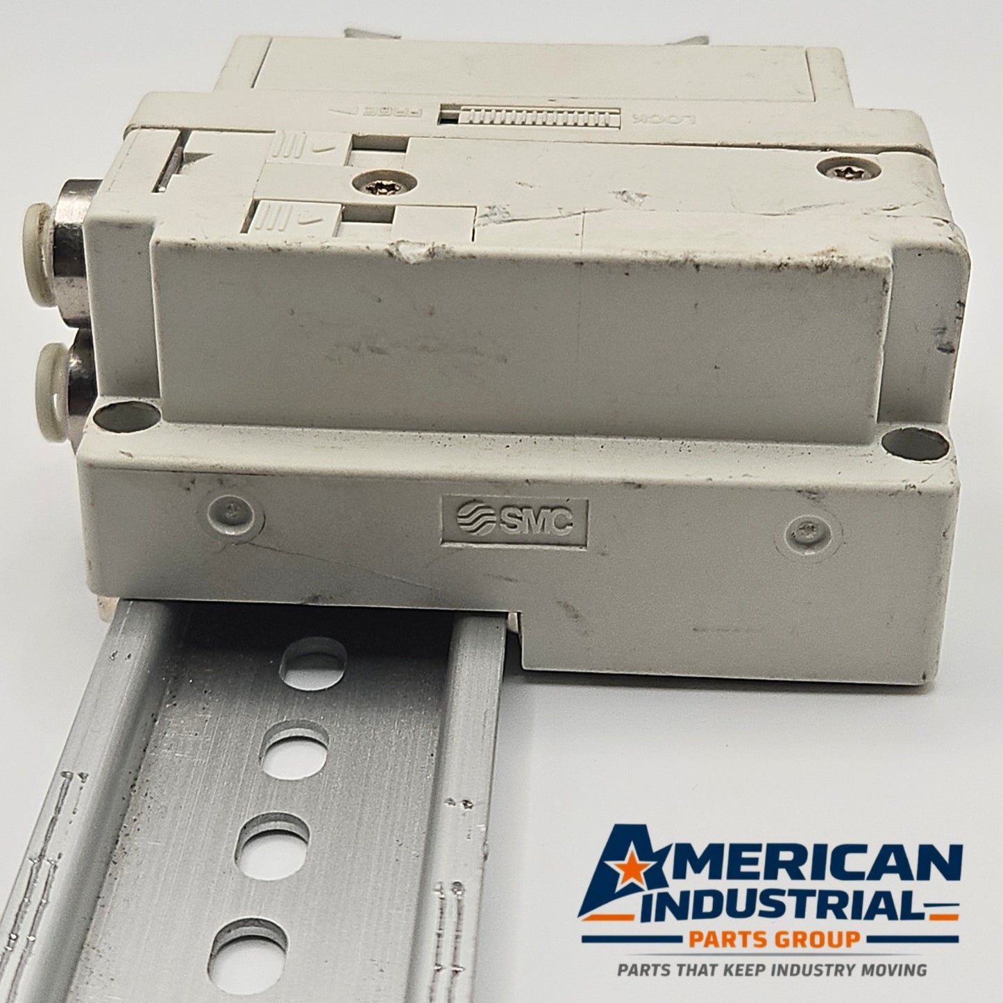 SMC pneumatic valve manifold end block rear view, industrial automation MRO pneumatic valve manifold component. American Industrial Parts Group.