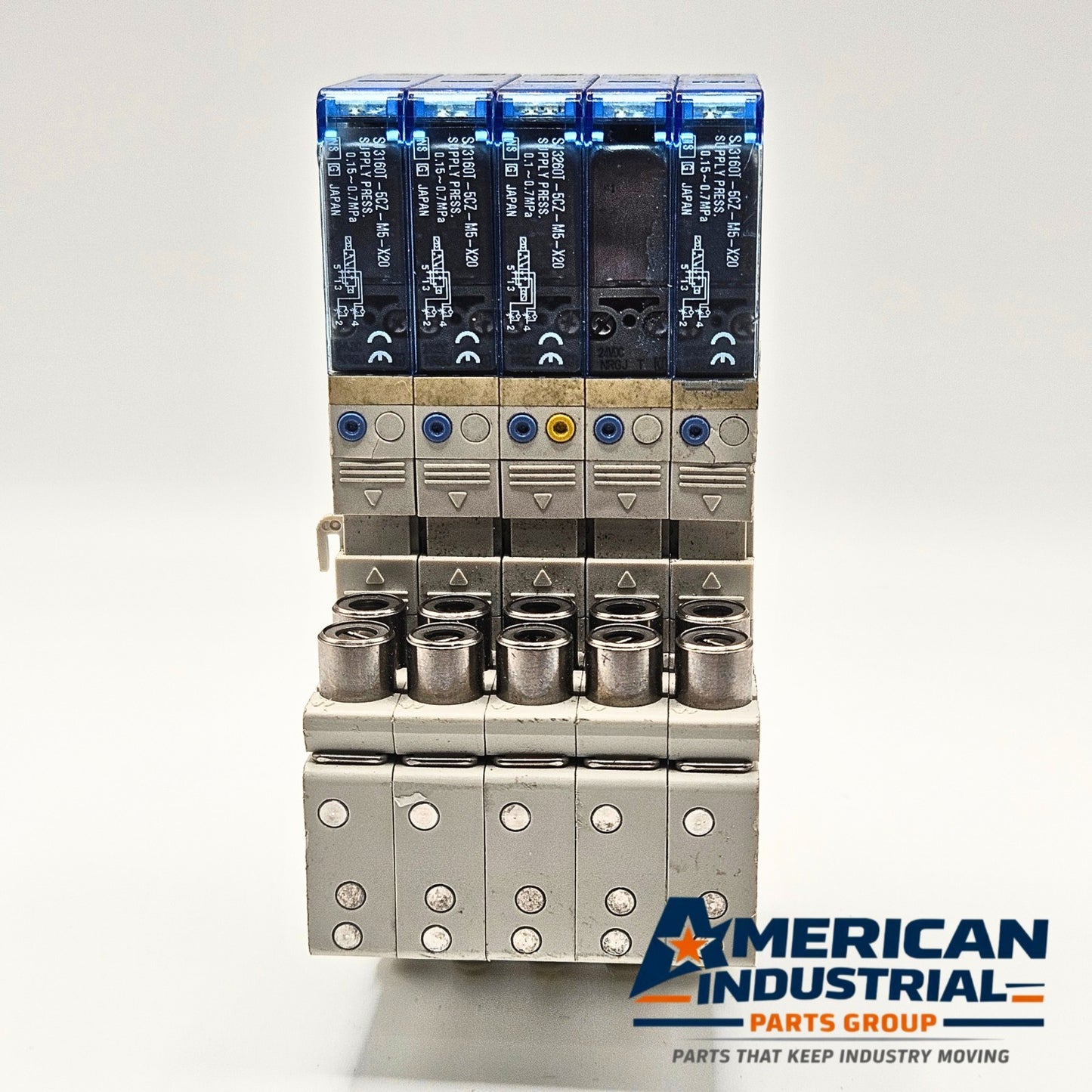 SMC SJ3160T-5CZ-M5-X20 pneumatic solenoid valve manifold lot of 5 front view, industrial automation MRO pneumatic valve assembly. American Industrial Parts Group.
