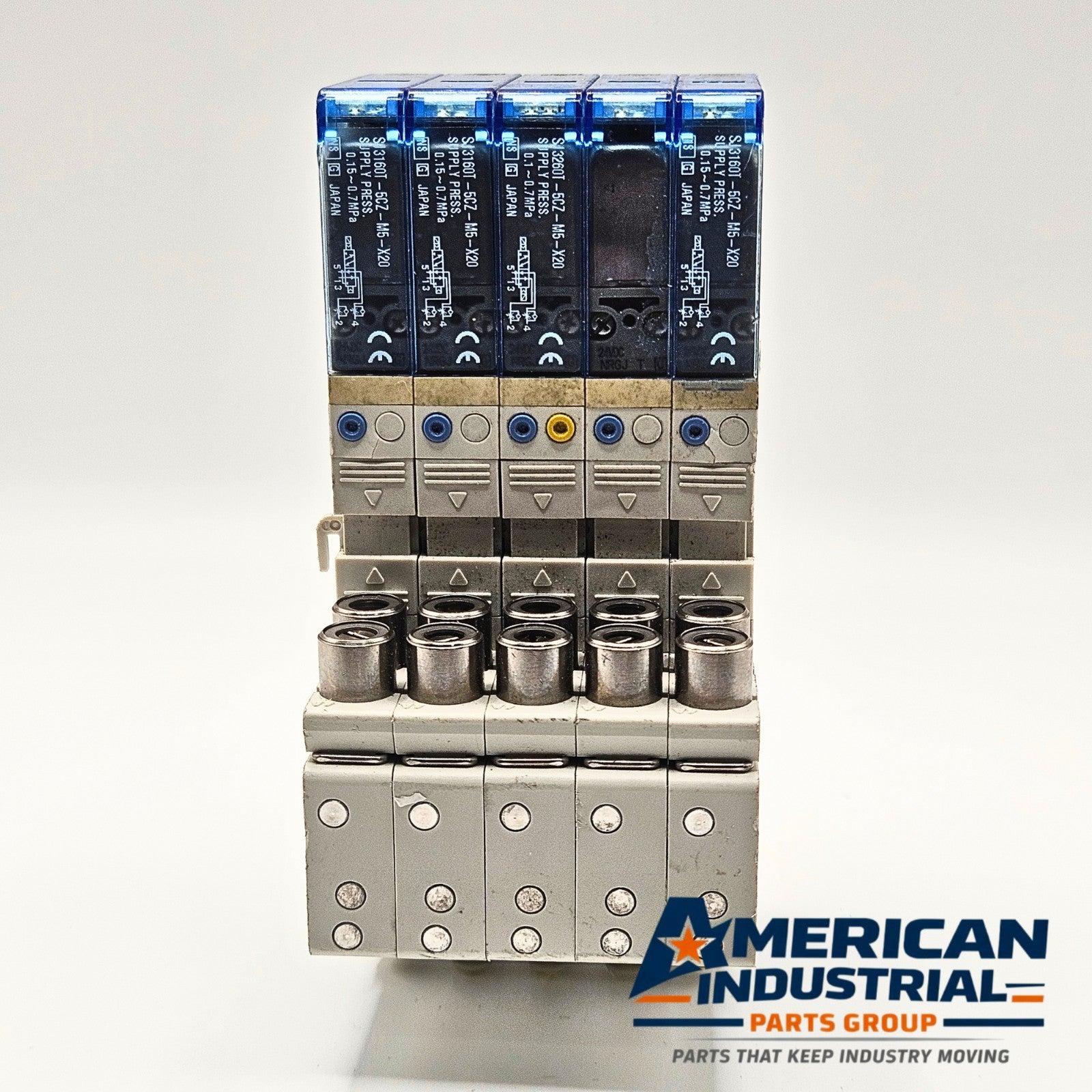 SMC SJ3160T-5CZ-M5-X20 pneumatic solenoid valve manifold lot of 5 front view, industrial automation MRO pneumatic valve assembly. American Industrial Parts Group.