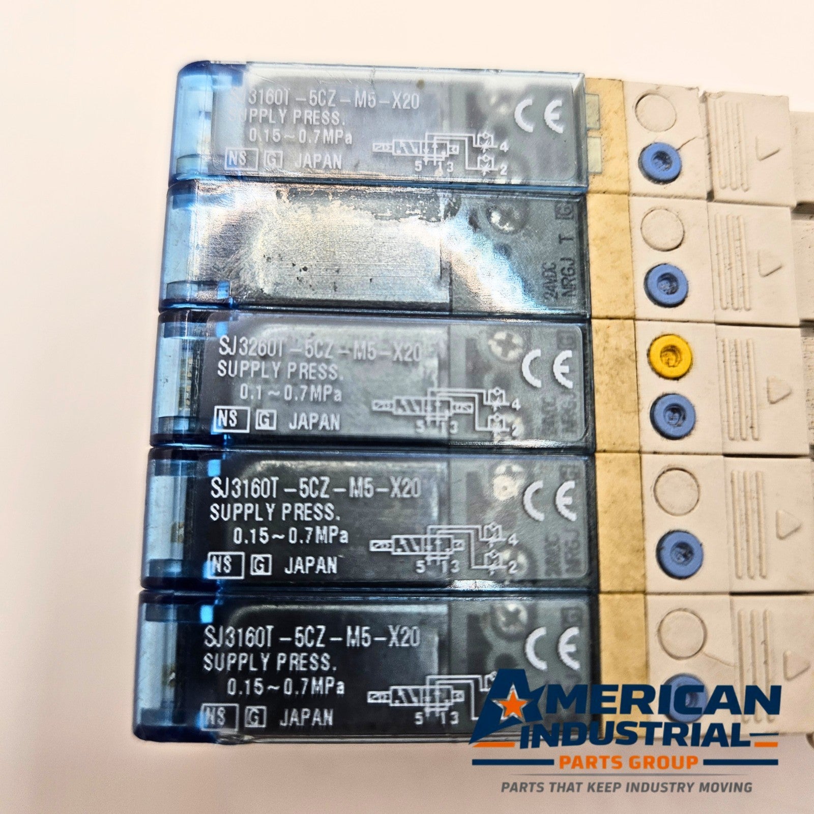 SMC SJ3160T-5CZ-M5-X20 pneumatic solenoid valve manifold mounting view, industrial automation MRO valve bank component. American Industrial Parts Group.